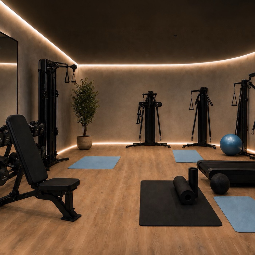 The performance gym, warm-lit with functional training equipment
